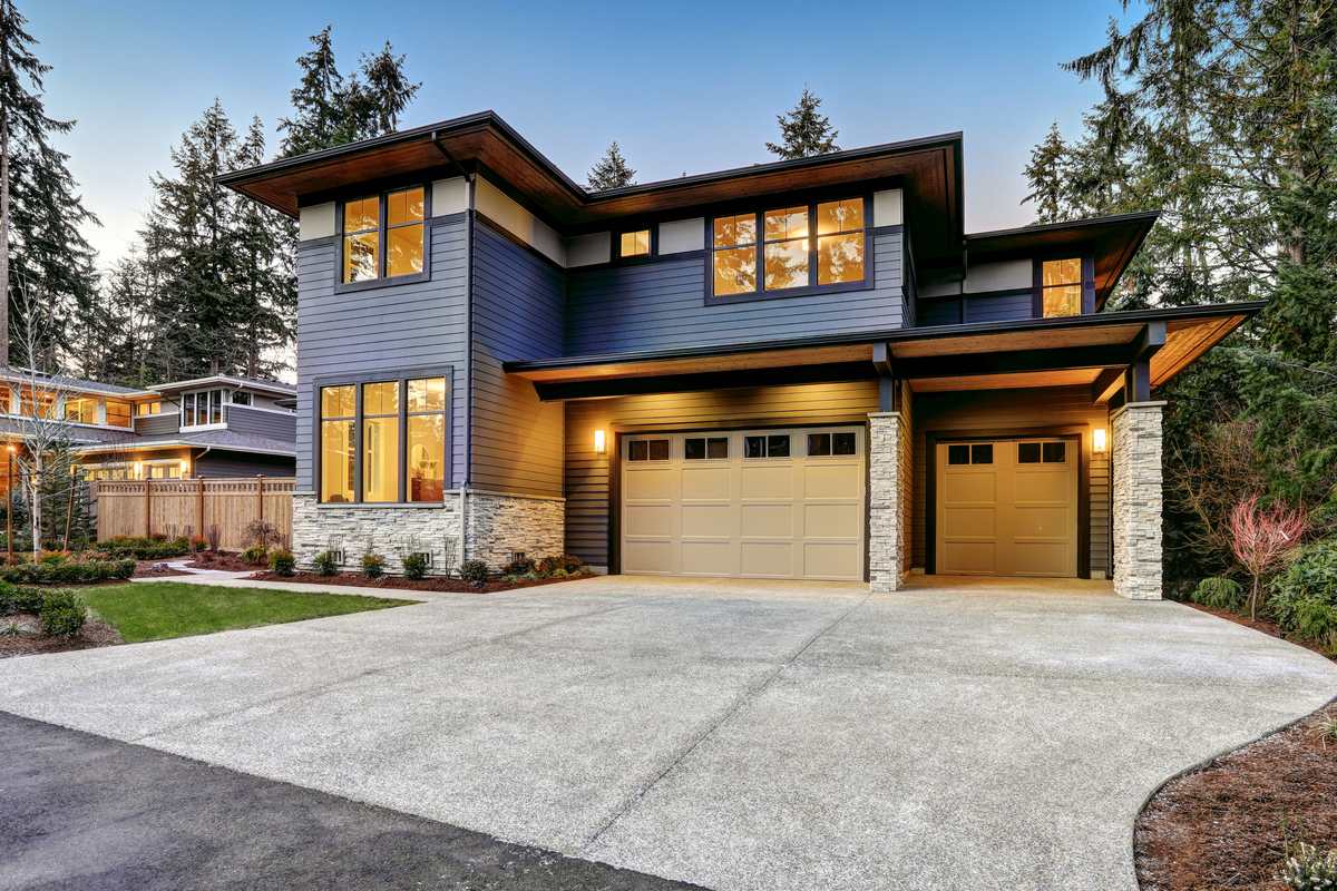 Modern two story home with a double garage and tall evergreens, a lot type to review under Bellevue DADU zoning