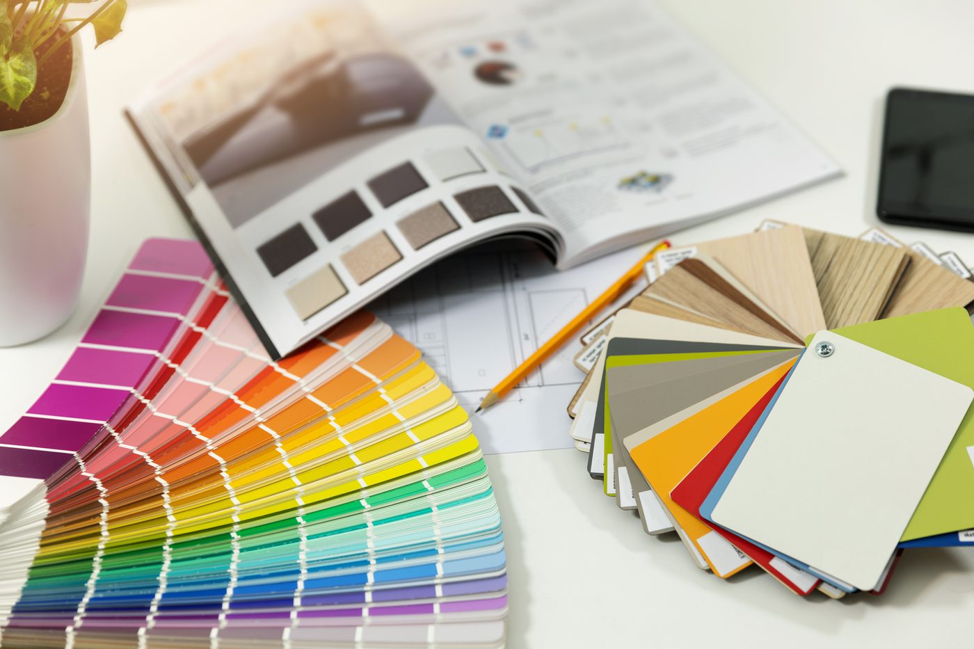 Fan of paint color swatches and material samples, showing the cosmetic side of customizable DADU plans