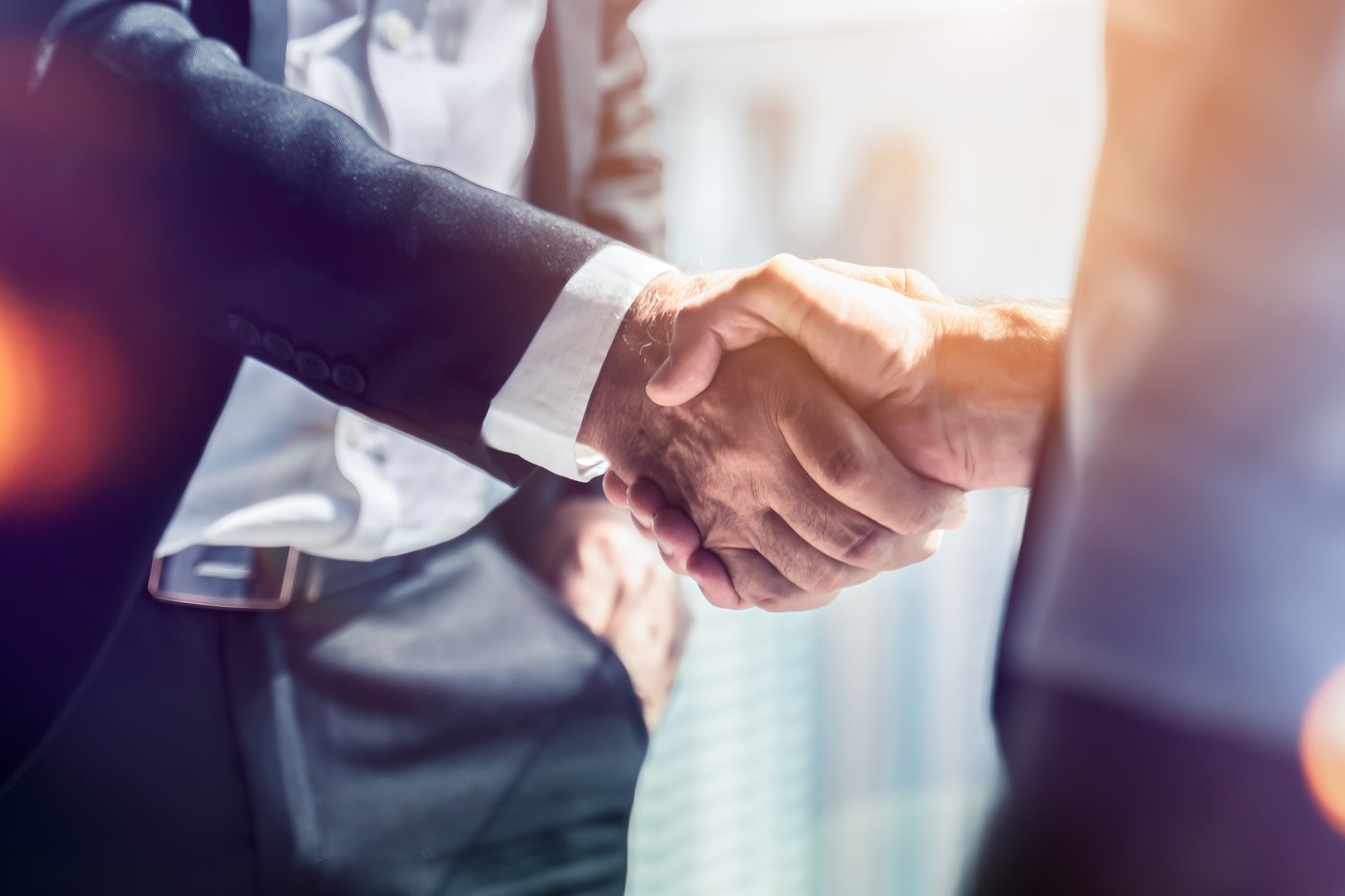 Two professionals shaking hands, a reminder that DADU builder references help homeowners choose with confidence