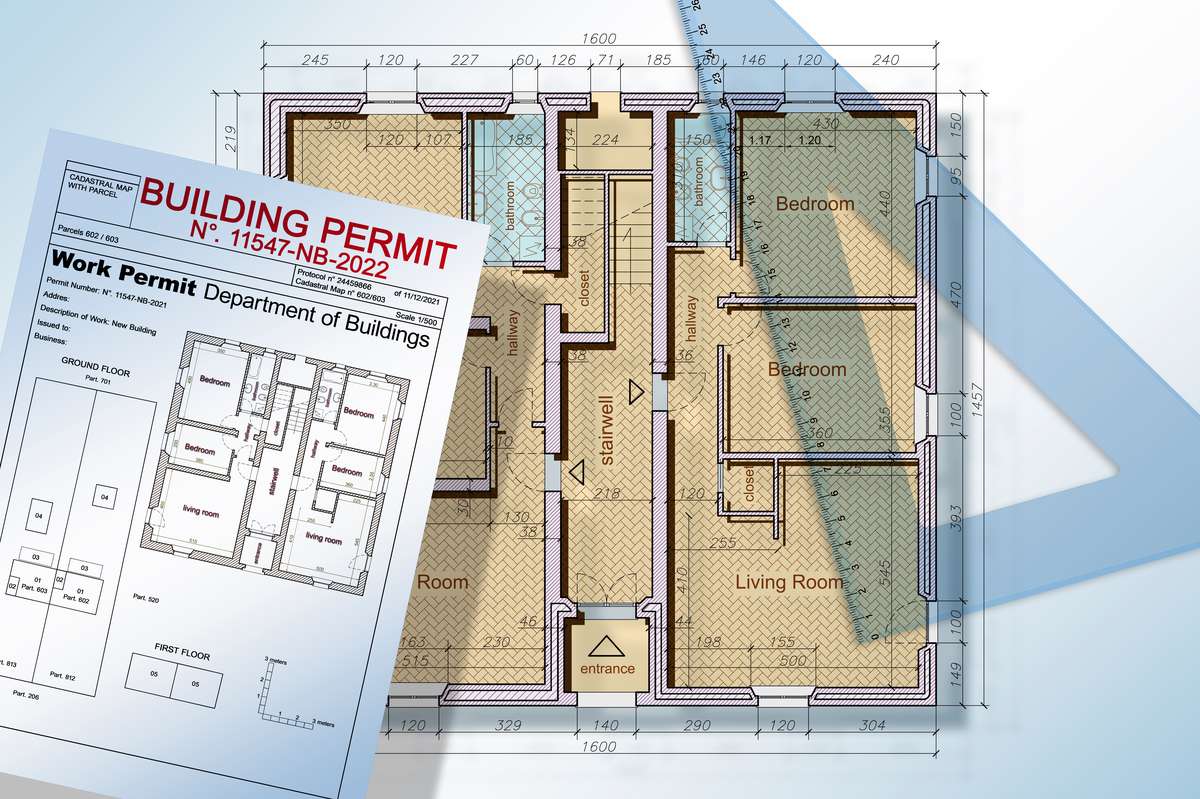 Building permit application form lying on a house floor plan, a reminder of DADU permit requirements