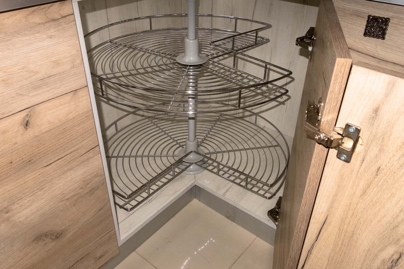 Rotating corner cabinet shelves pulled out of a kitchen cabinet, a smart piece of DADU storage planning